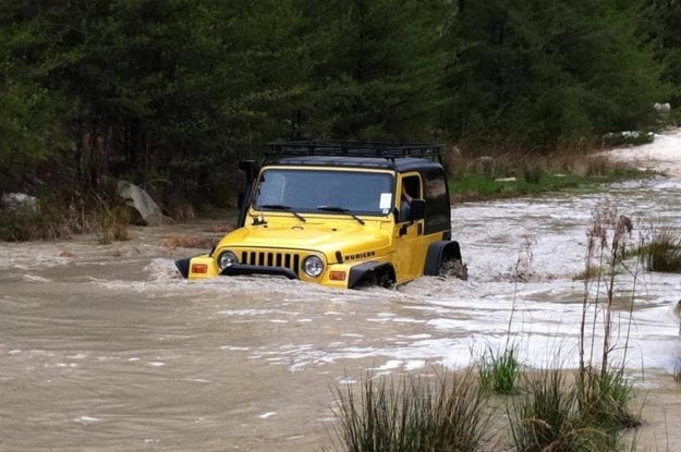 yellow jeep in water