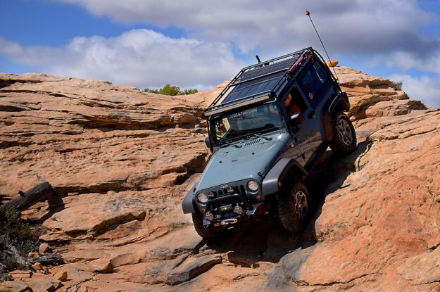 blue jeep going down rocks