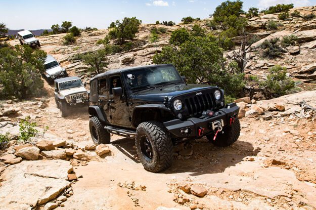 row of jeeps at arch canyon