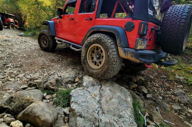 red jeep on a rock