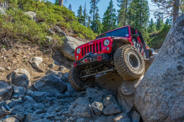 red rubicon jeep on rocks