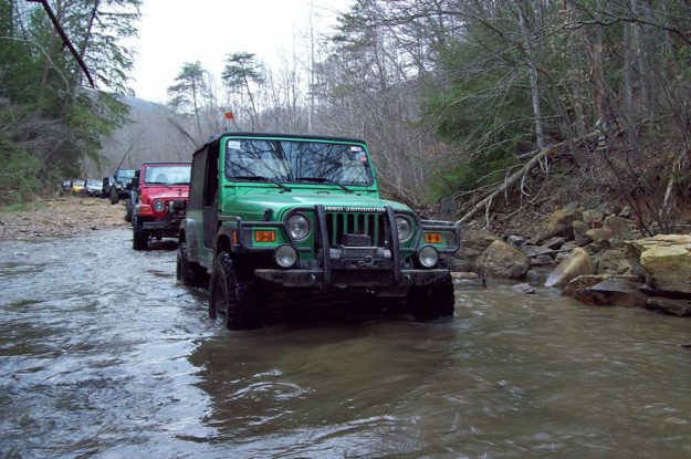 green jeep in river