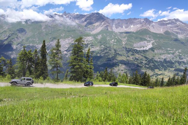 three jeeps on dirt road in alps