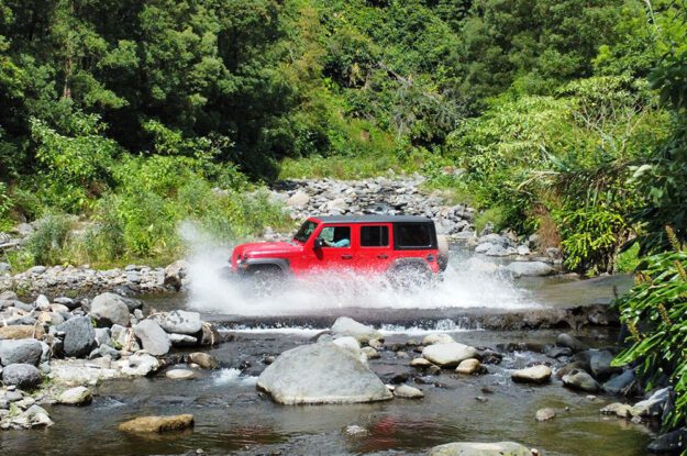 red jeep crossing stream