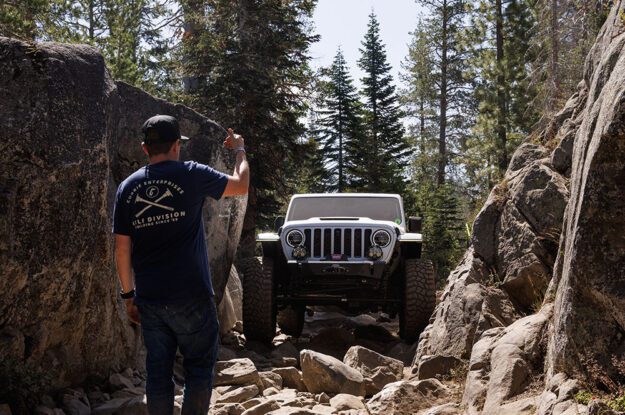 Casey Currie guides Jeep between rocks.