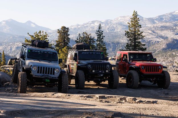 Three Jeeps with a mountain background.