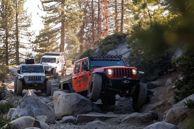 Three Jeeps descending rocky trail.