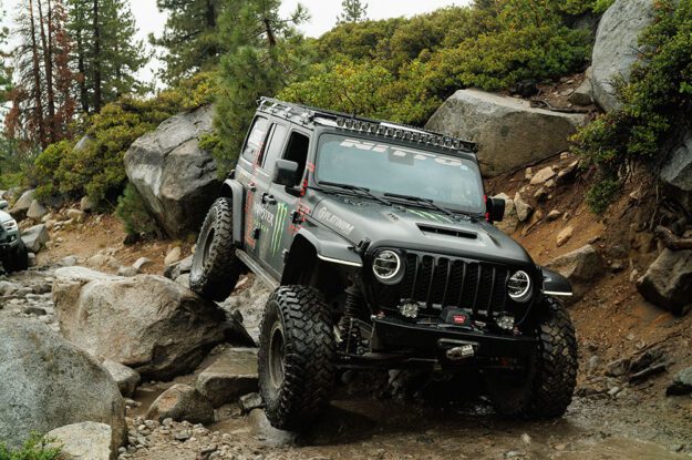 Casey Currie's Jeep with rear tire on a rock.