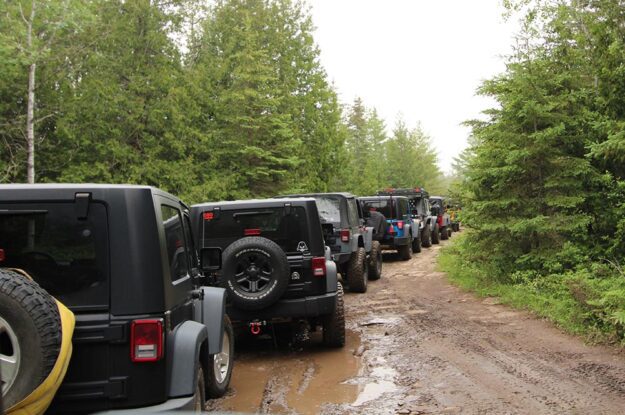 row of jeeps in mud