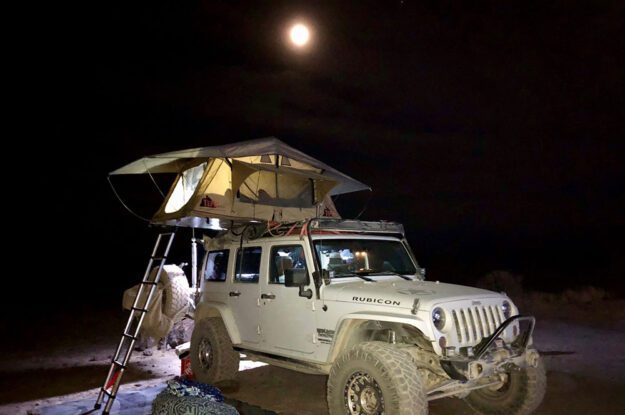 jeep setting up camp in the dark