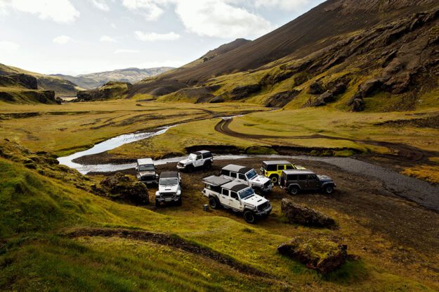row of jeeps in iceland valley