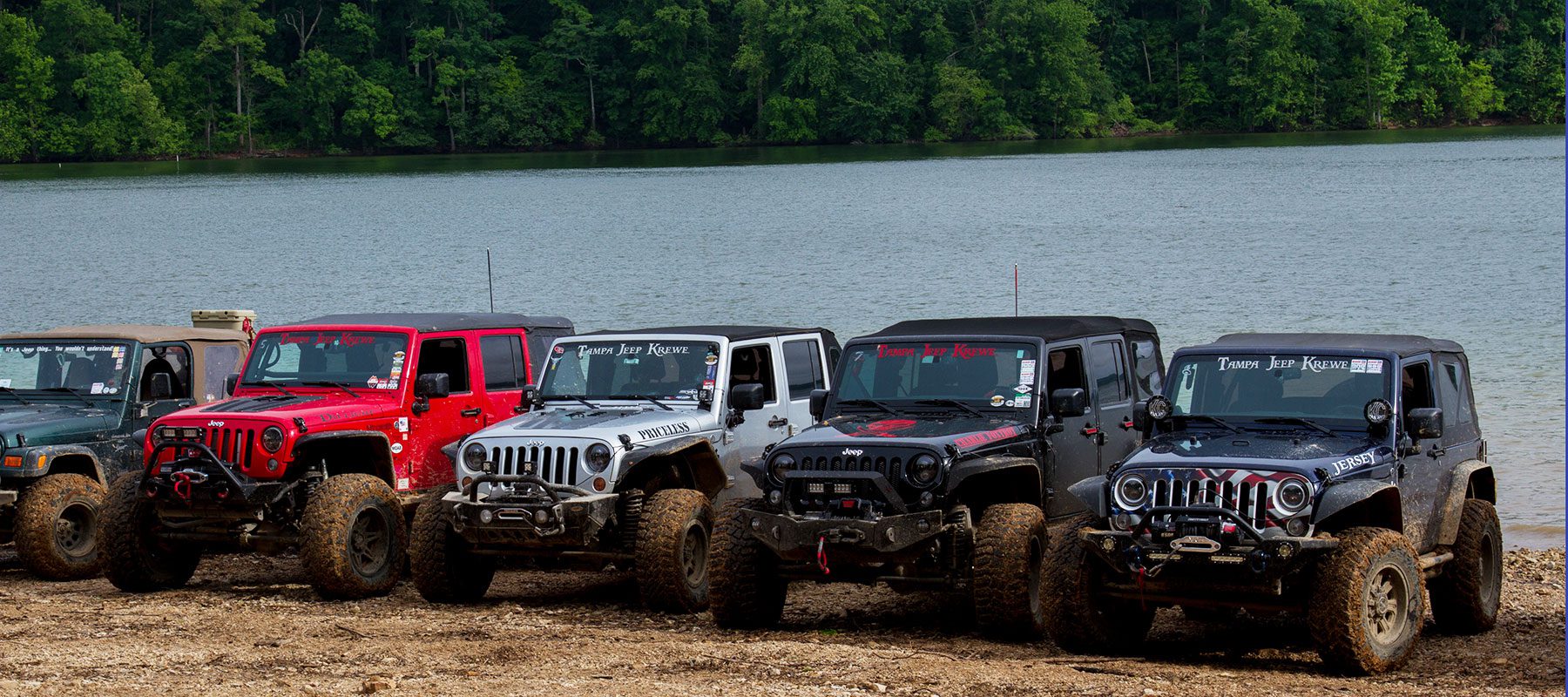 jeeps lined up by lake
