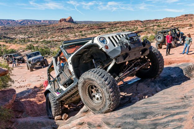 Jeep crawling up slick rock.