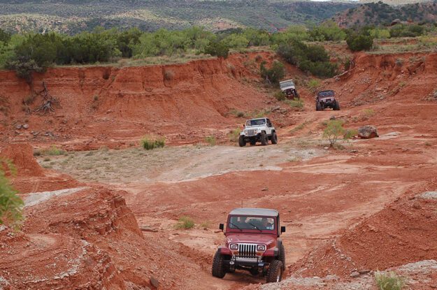 row of jeeps in red valley