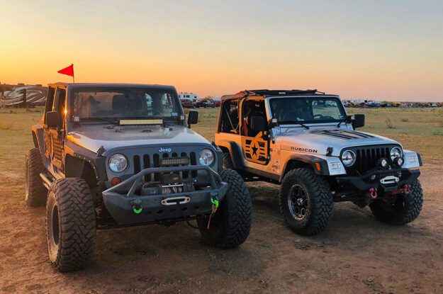 two jeeps at sunset