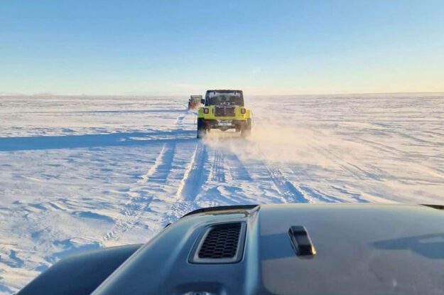 two jeeps driving on snow