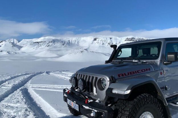 black jeep by tracks in snow