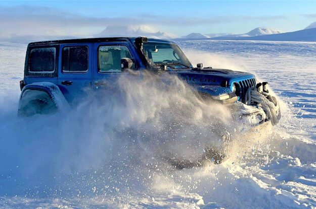 jeep driving through deep snow
