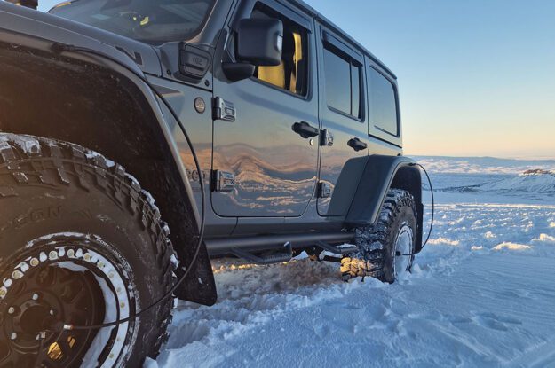 side view of jeep in snow