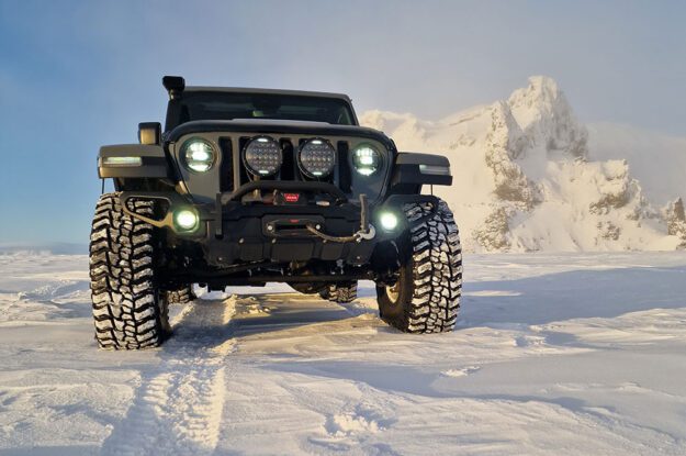 black jeep in snow and sunshine