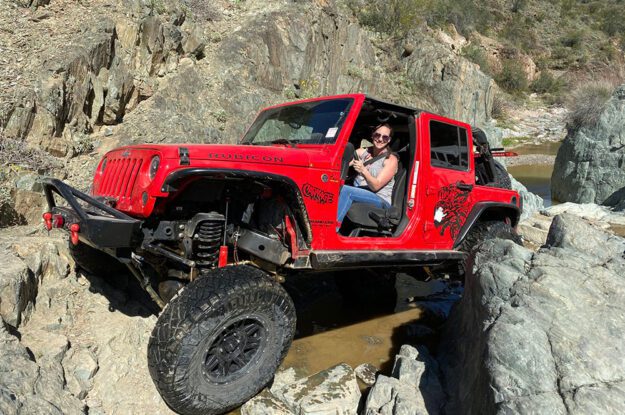 woman driving red jeep