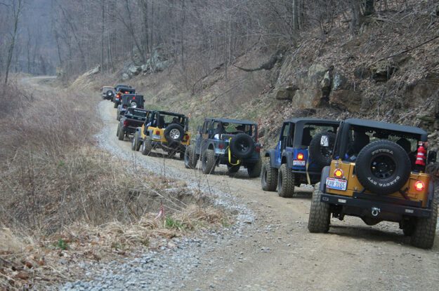 row of jeeps along rocks