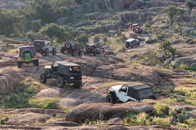 jeeps curving up hillside
