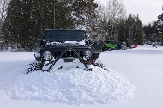 black jeep and pile of snow