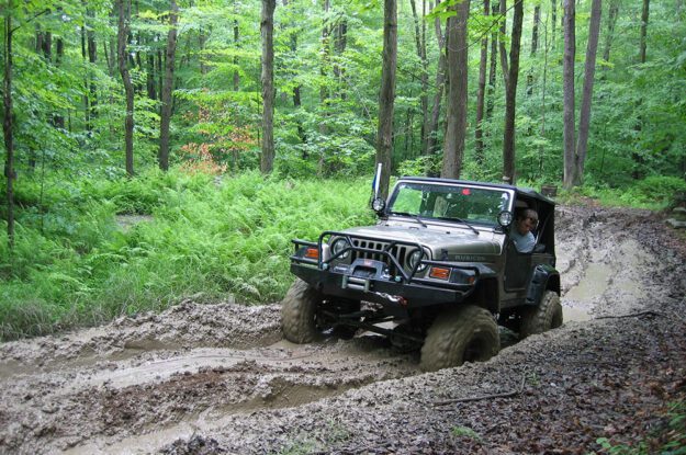 Jeep in muddy rutted road