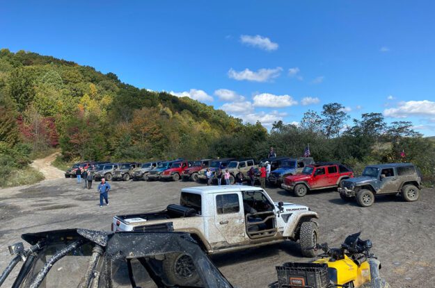 Jeeps in a dirt parking area