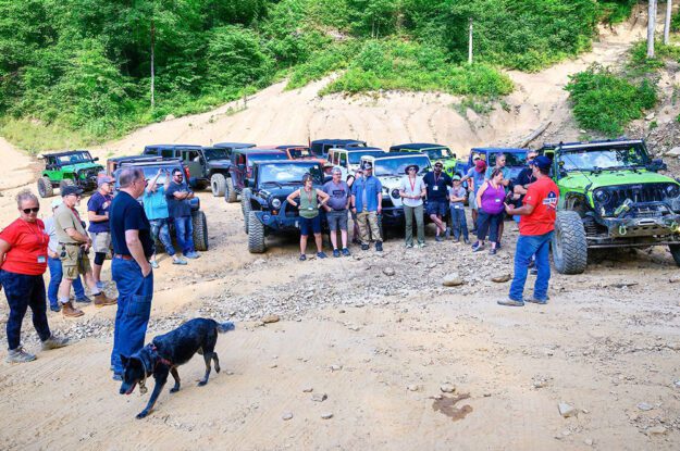 Jeeps parked with people listening to a trail guide