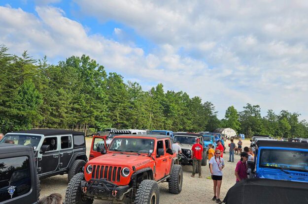 Jeeps lined up with people