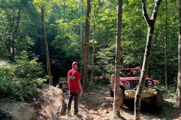 Trail guide watching jeeps come up hill