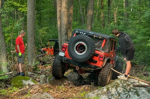 Jeep driving over rocks