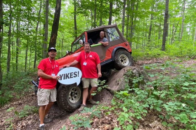 Trail guides and jeep with yikes sign