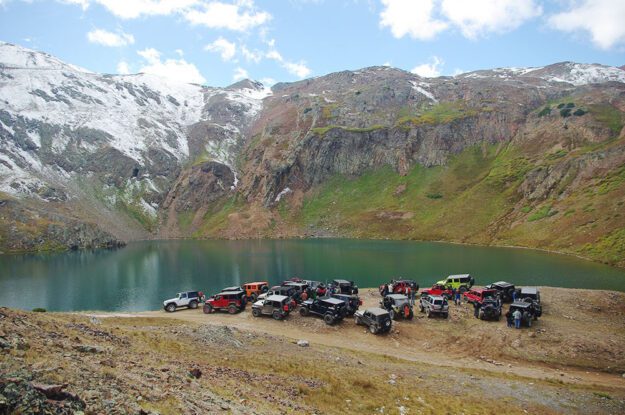 Jeeps parked above a lake