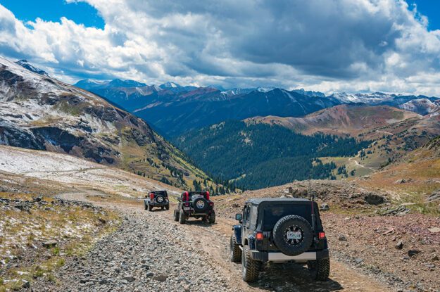 Jeeps with a cloudy sky