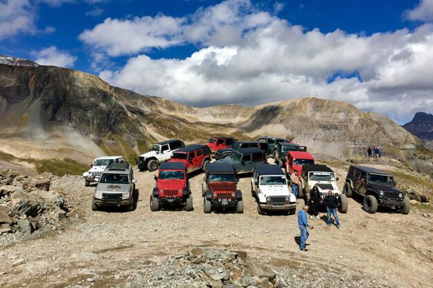 Jeeps parked with mountains in the background