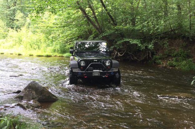 Jeep crossing a stream