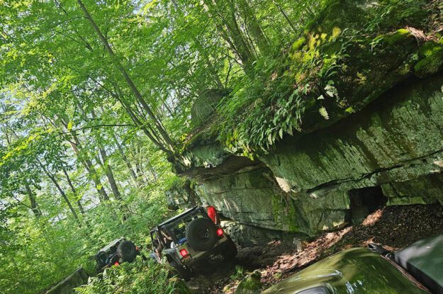 Jeeps near rock outcroping