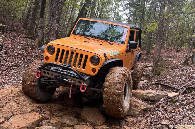 orange jeep on rocks