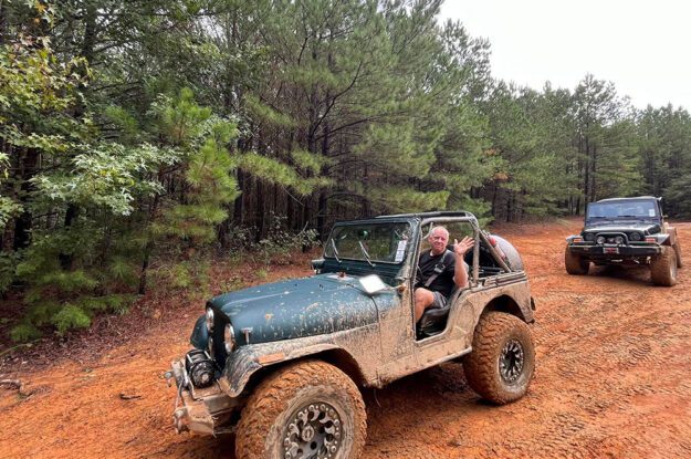 guy waving from jeep