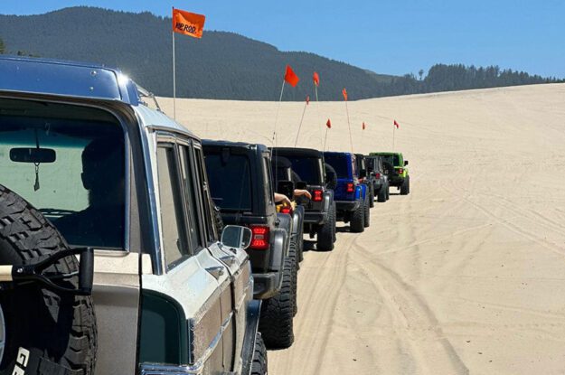 Jeeps with flags single file