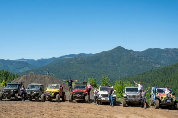 People posing with their jeeps