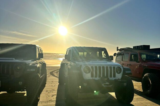 Jeeps with sun rays behid