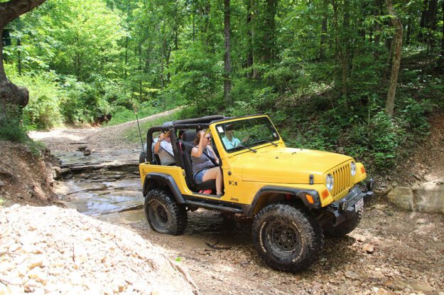 yellow jeep in water