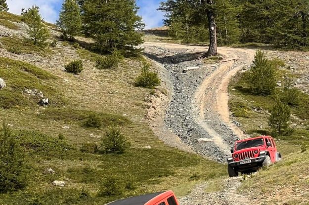 red jeeps in mountains