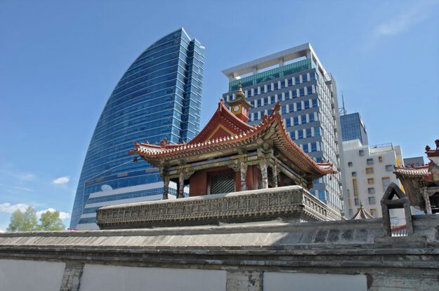 temple with skyscrapers behind it
