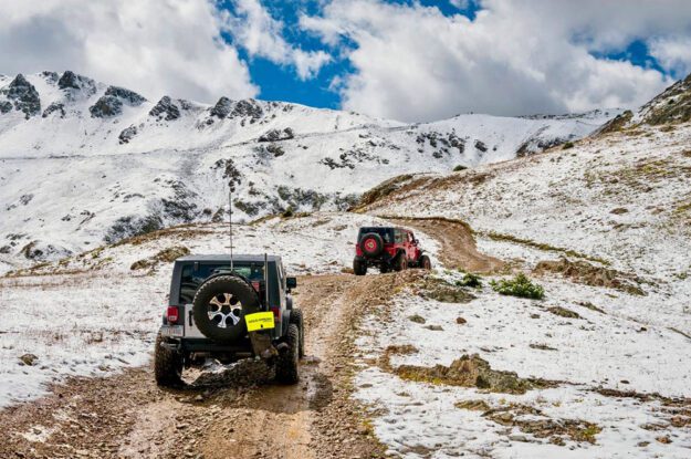 two jeeps snowy road